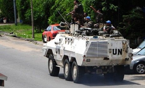 An armored UN truck patrols the streets in the Ivory Coast: President Laurent Gbagbo still refuses to cede power as violence continues.