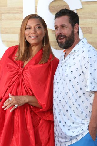 Queen Latifah poses on the red carpet with Adam Sandler