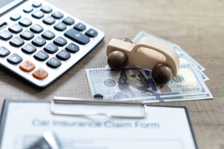 Vehicle insurance claim form, calculator and money 