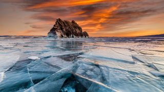 Sunset on Lake Baikal in winter near Elenka island.