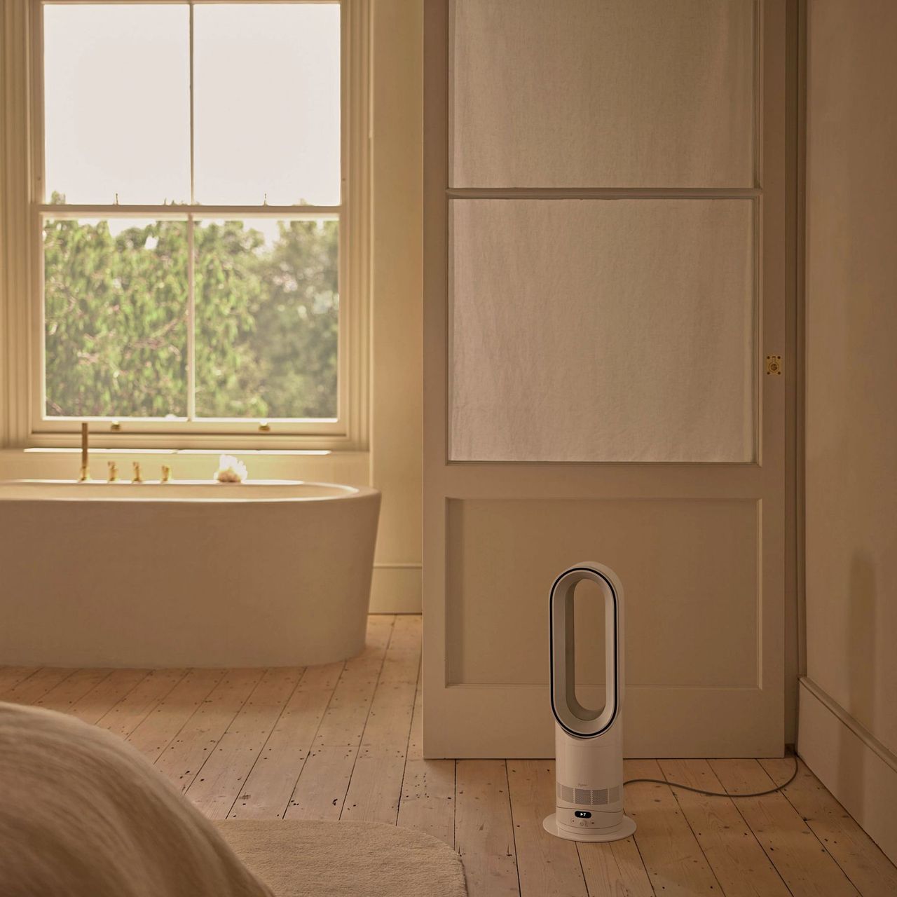 Dyson Hot+Cool HF1 Fan Heater on the floor in a bathroom with wooden floors and a freestanding tub
