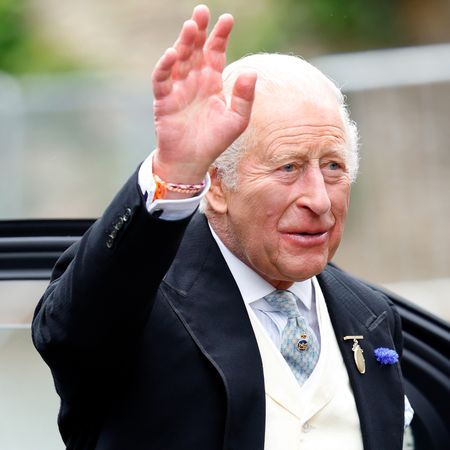 King Charles waving at Peter Phillips's wedding