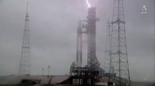 Lightning strikes the umbilical tower of NASA's moon-bound Space Launch System rocket during preparations for a critical Artemis 1 fueling test on April 2, 2022.