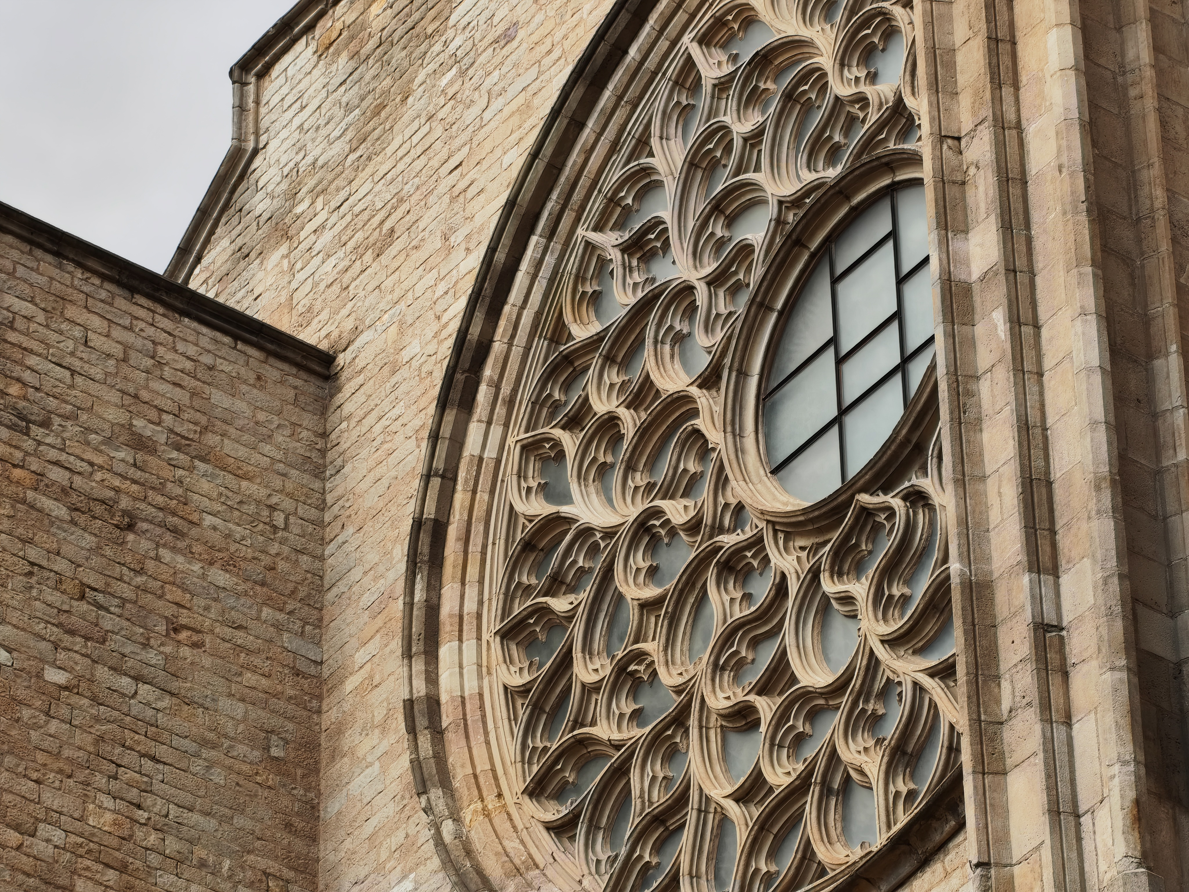 Detailed close-up of the intricate rose window on a Gothic church in Barcelona, captured with the Nothing Phone (4a).