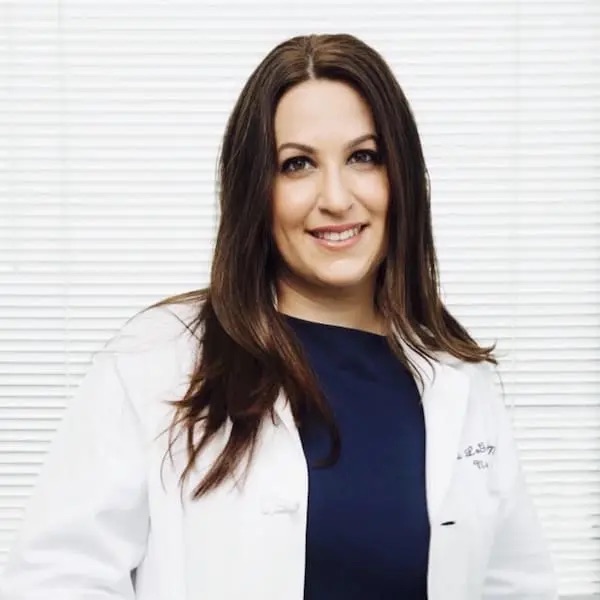 a doctor with a white coat standing in front of a white background