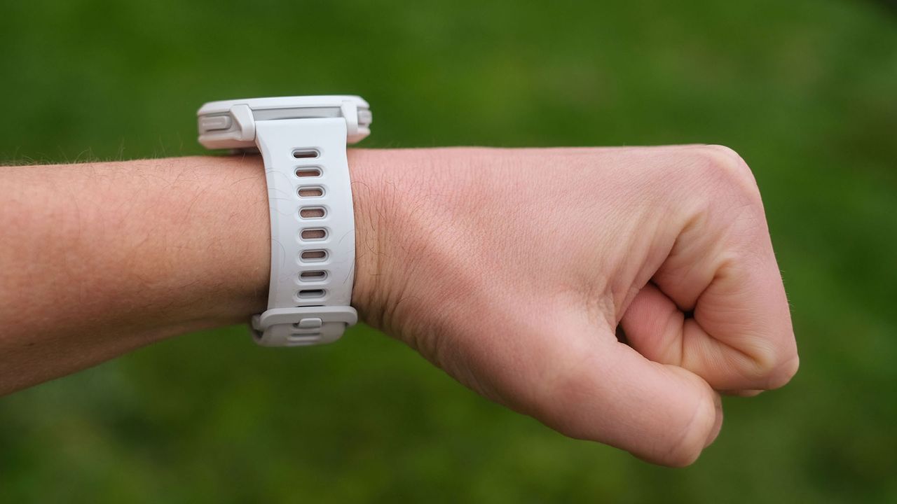 A close-up picture of our reviewer wearing the Coros Pace 4 watch, a view from the side