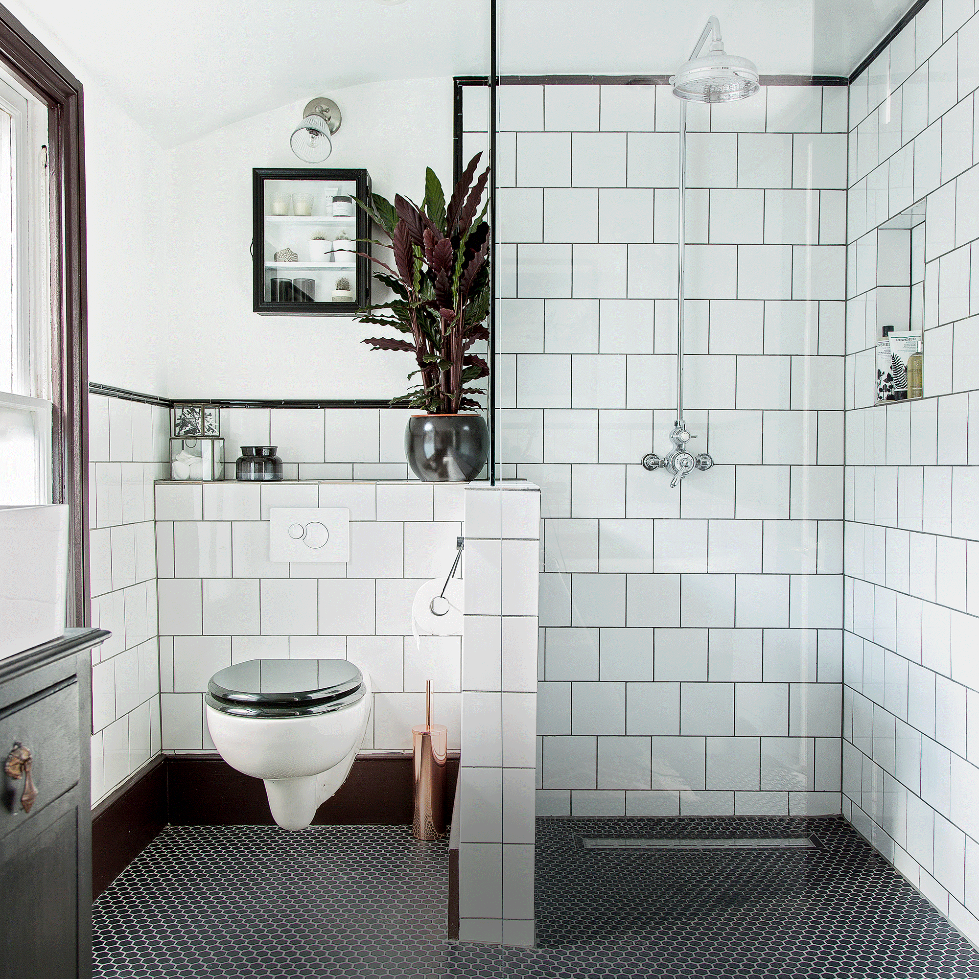 Walk in shower with white tiles and toilet