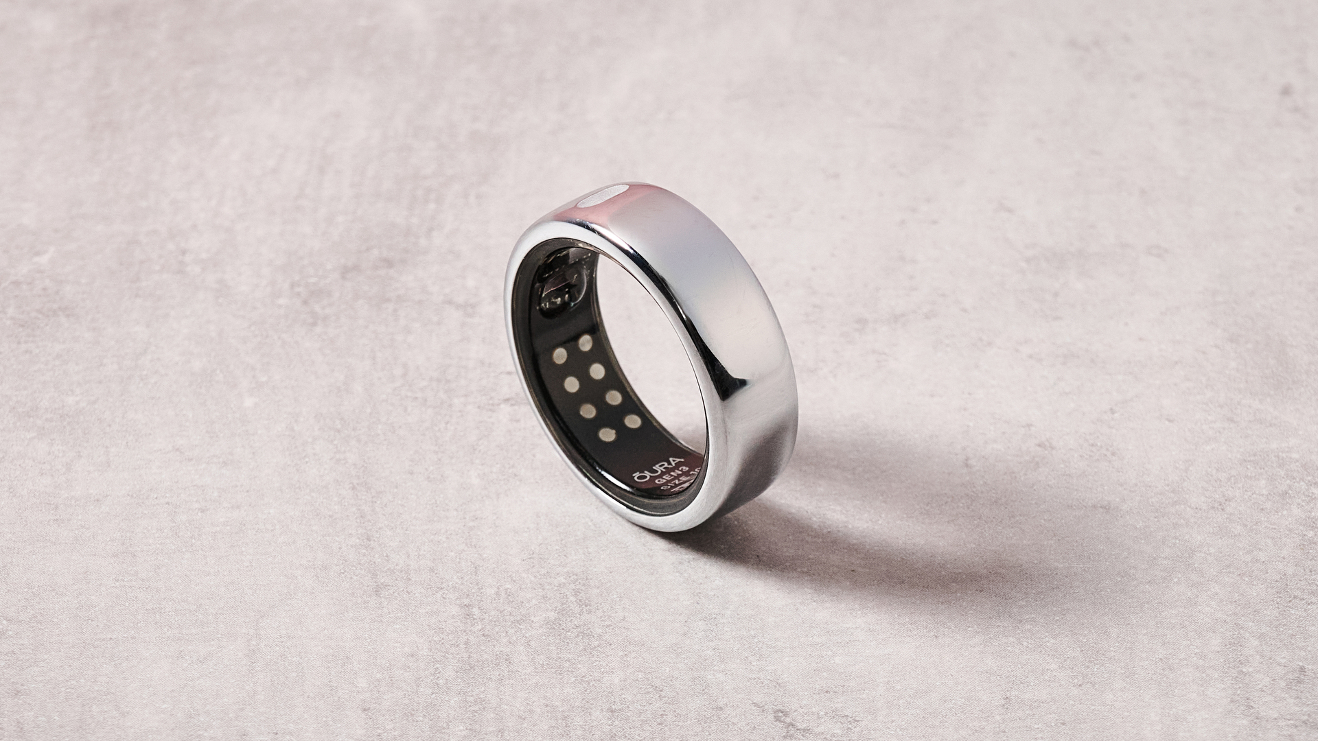 The Oura Ring 3 upright on a table, showing the internal sensors.