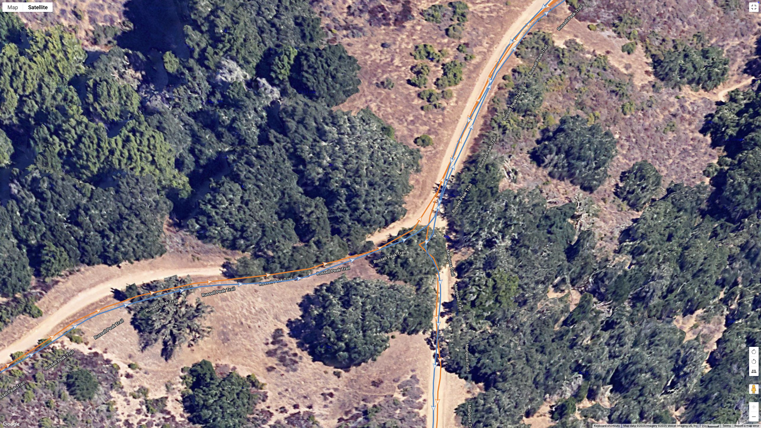 A Google Maps satellite view showing how the COROS APEX 4 (blue) and Garmin Forerunner 970 (orange) compare for GPS-tracked accuracy on a hilly, windy hike.