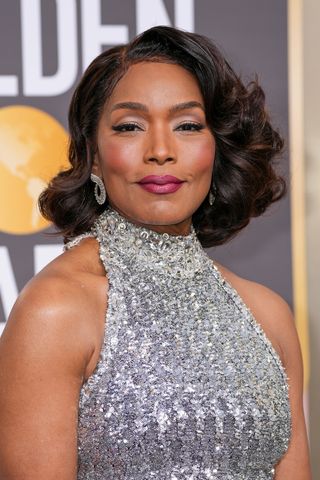 Angela Bassett is pictured with a side-swept, curly bob as she attends the 80th Annual Golden Globe Awards at The Beverly Hilton on January 10, 2023 in Beverly Hills, California. 