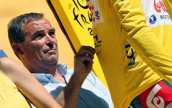 Five-time Tour winner Bernhard Hinault performing his jersey zipping duties for Cadel Evans.