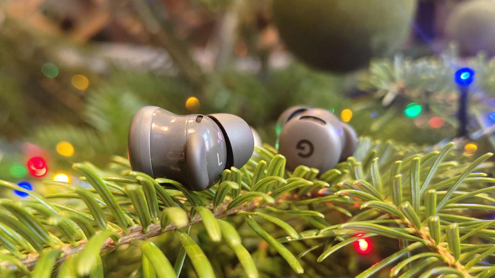 The Google Pixel Buds 2a buds on a tree.