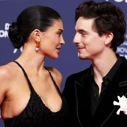 Kylie Jenner and Timothee Chalamet on a red carpet in matching black outfits