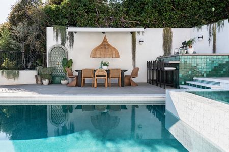 An outdoor kitchen next to a pool