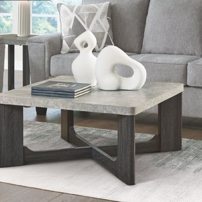 A stone-topped coffee table with ornaments from Ashley Furniture