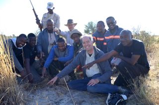 Members of the search team that found a meteorite fragment from the asteroid 2018 LA point to the fallen space rock.