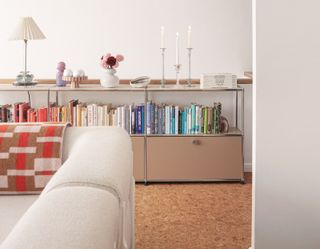 A living room with a bookcase organized by color