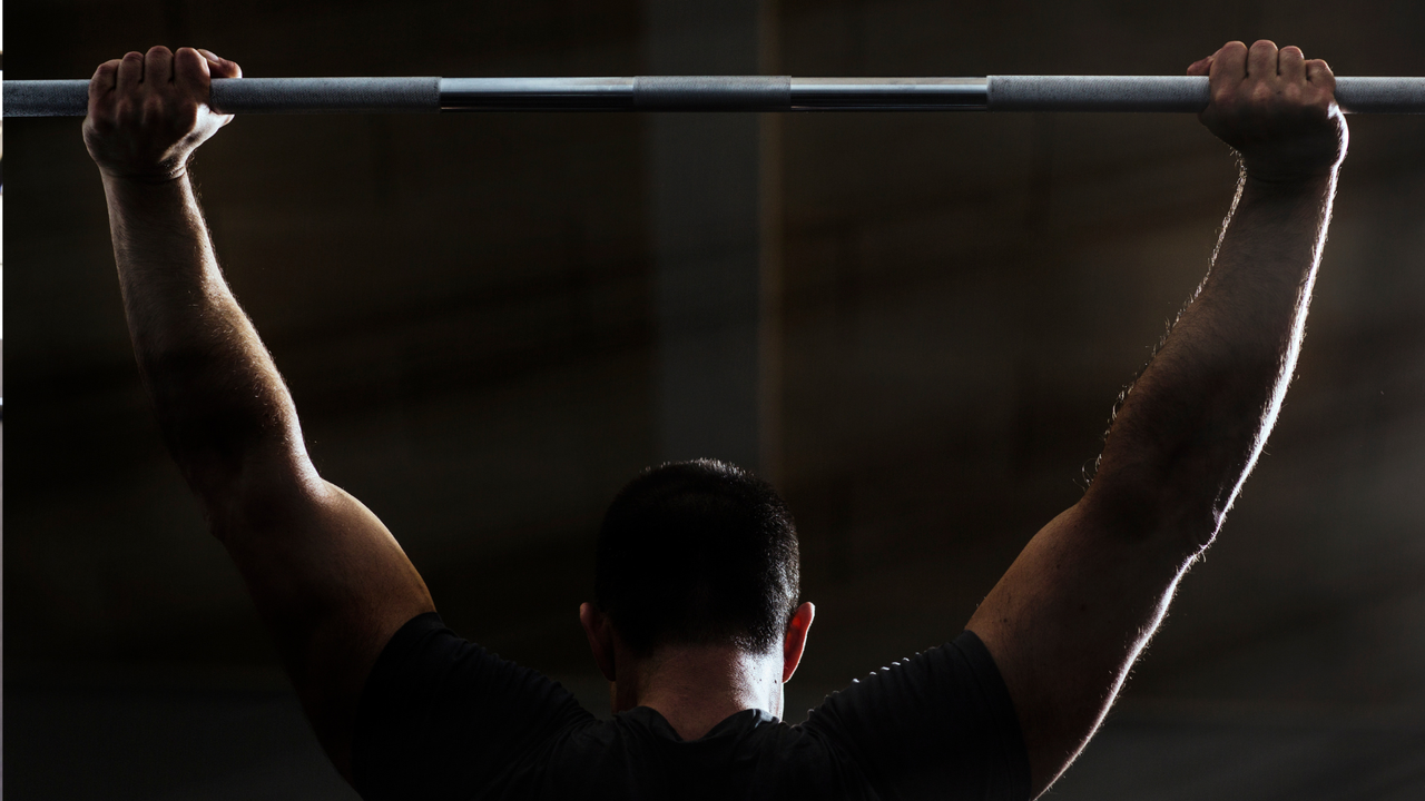 man doing barbell exercises