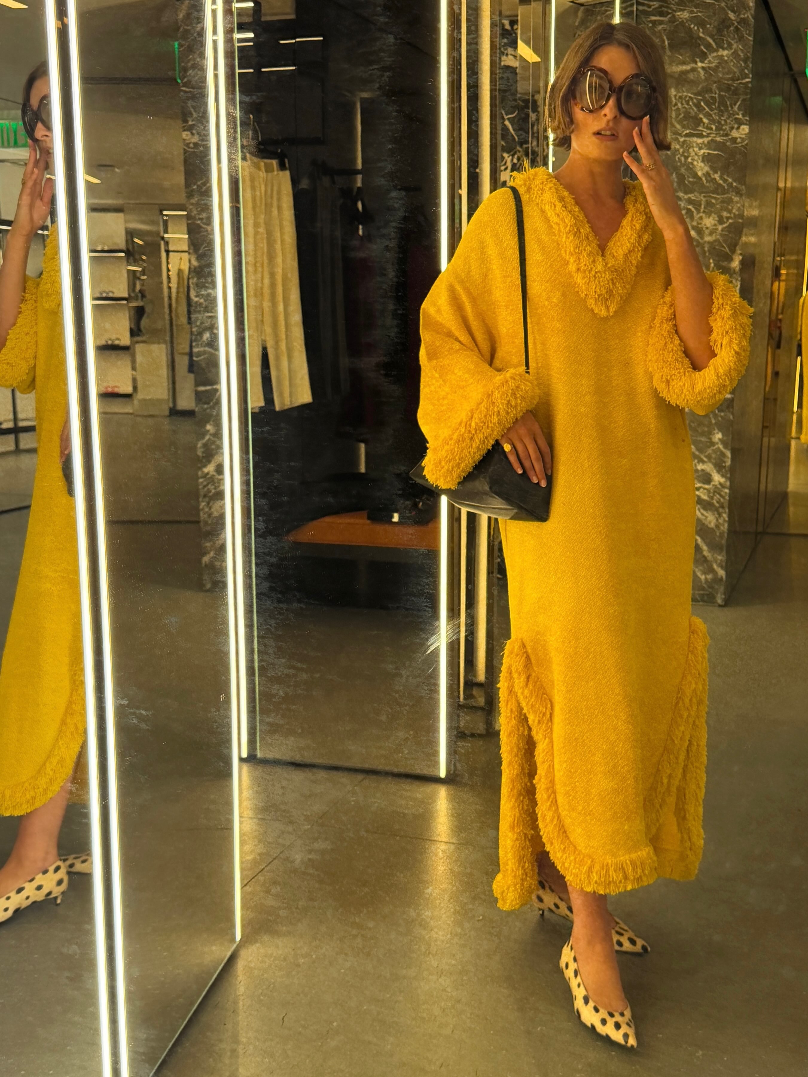 An image of @christietyler wearing a yellow kaftan from Celine.