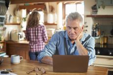Mature man using a laptop at home