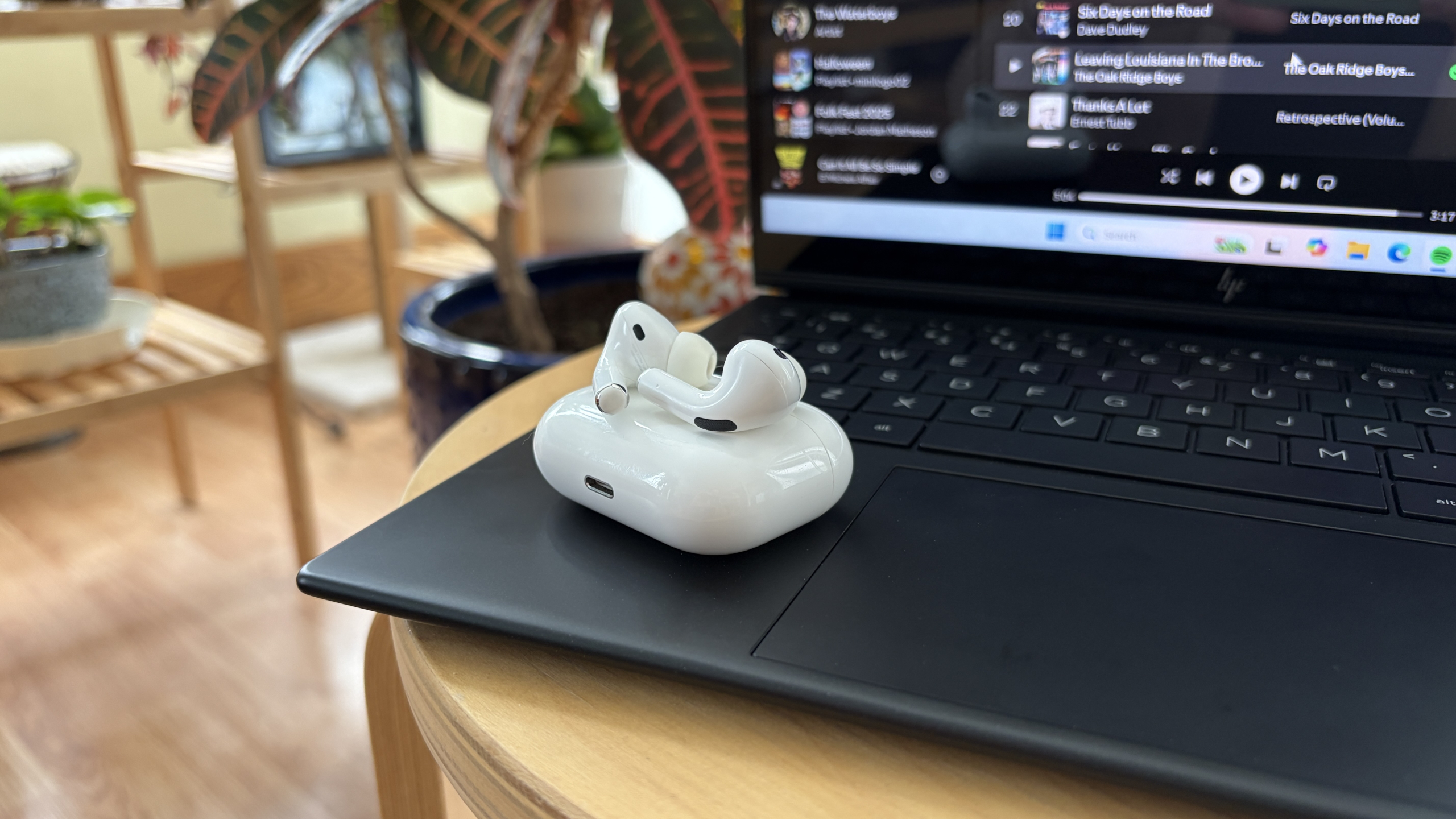 AirPods Pro sitting on an HP laptop