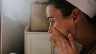 woman applying face serum