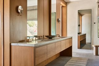 A neutral bathroom layered with natural materials