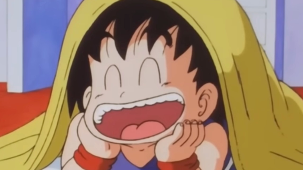 Goku laughing while under a blanket