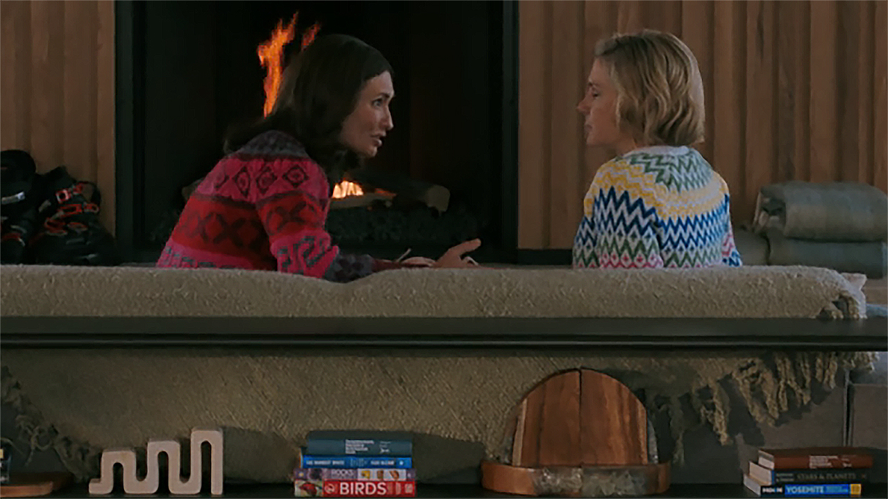 Zosia and Carol talking while sitting on a couch in Pluribus episode 9