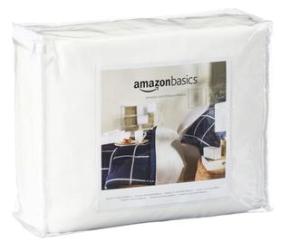 The Amazon Basics Mattress Protector in its bag on a white background