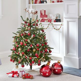 Decorated small Christmas tree with a red theme