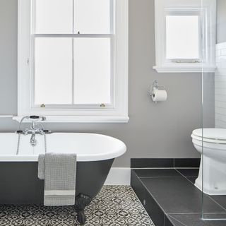 bathroom with bathtub and printed tiled flooring