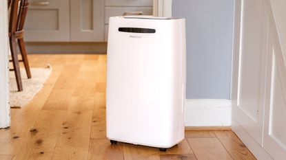 The Pro Breeze 50-pint Dehumidifier on a hard wood floor in a home environment