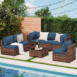 A dark blue and dark wicker outdoor lounge set