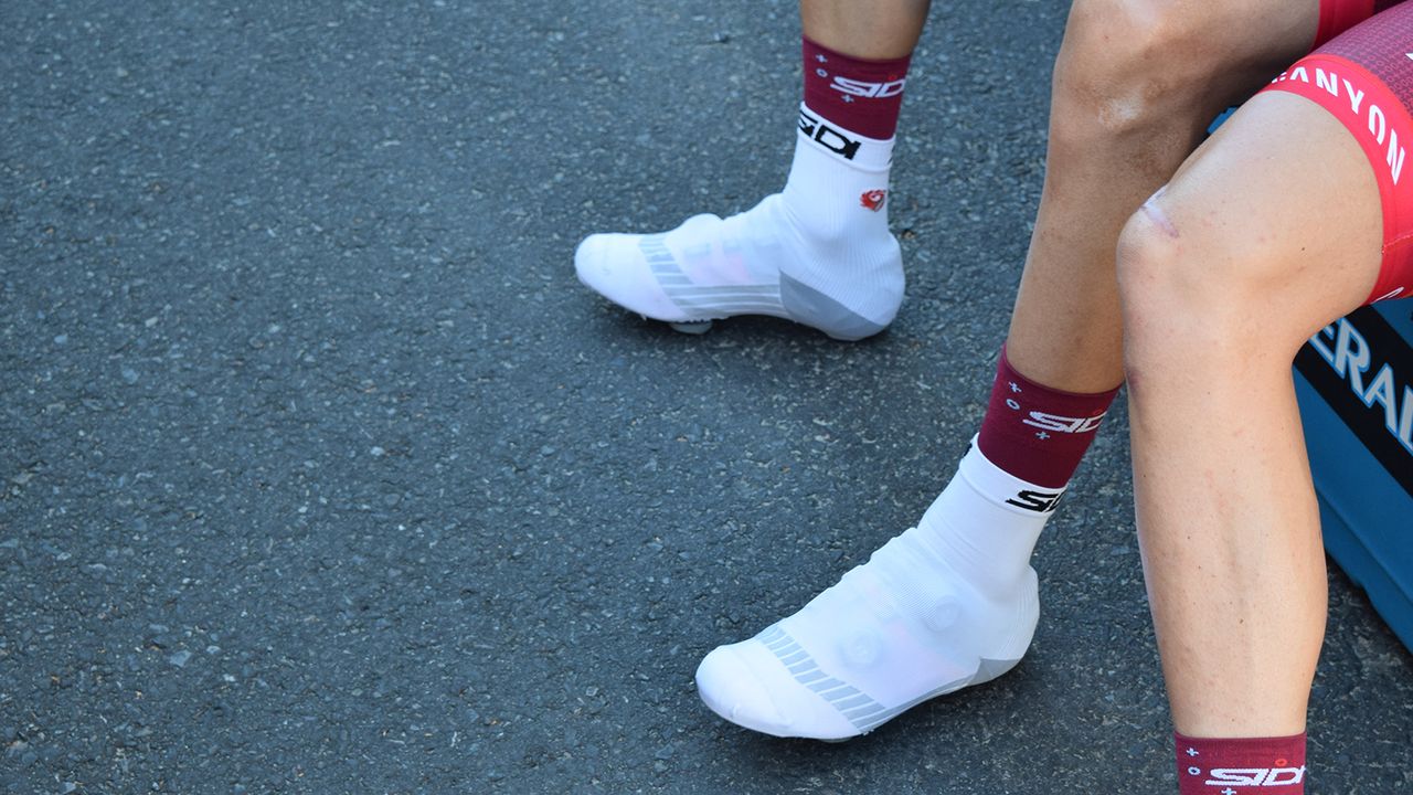 Some riders choose not to wear sponsor correct shoes and cover up their preferred shoes with oversocks