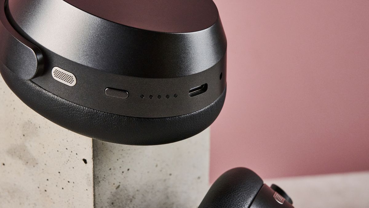 A closeup of the microphone, button and USB-C port on the bottom of the Sennheiser Momentum 5's right earcup.