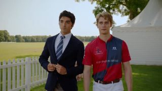 Alex and Henry stand next to each other in a field in Red, White. and Royal Blue