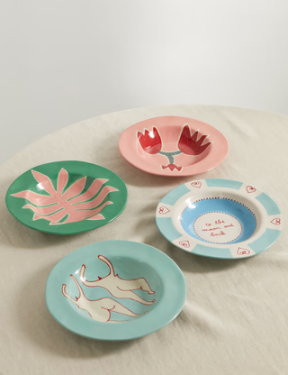 four deep plates with different colorful designs painted on them
