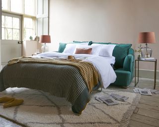 Guest room with teal green sofa bed by Loaf