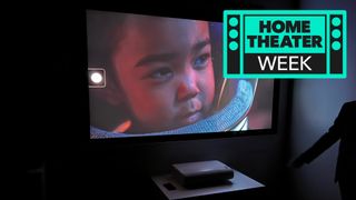 Samsung&#039;s The Premiere 9 in a dark room showing a colorful image of a child in a space suit