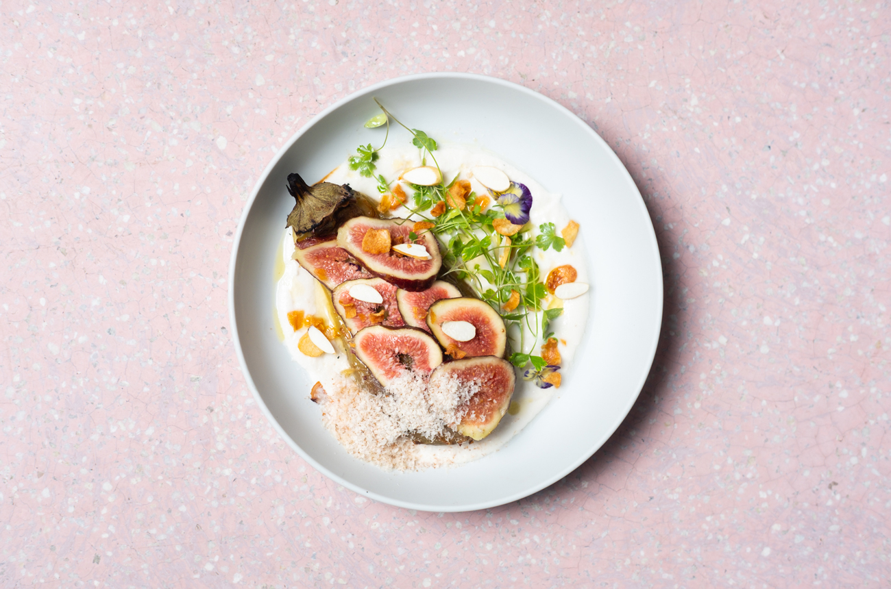A plate of food against a pink background