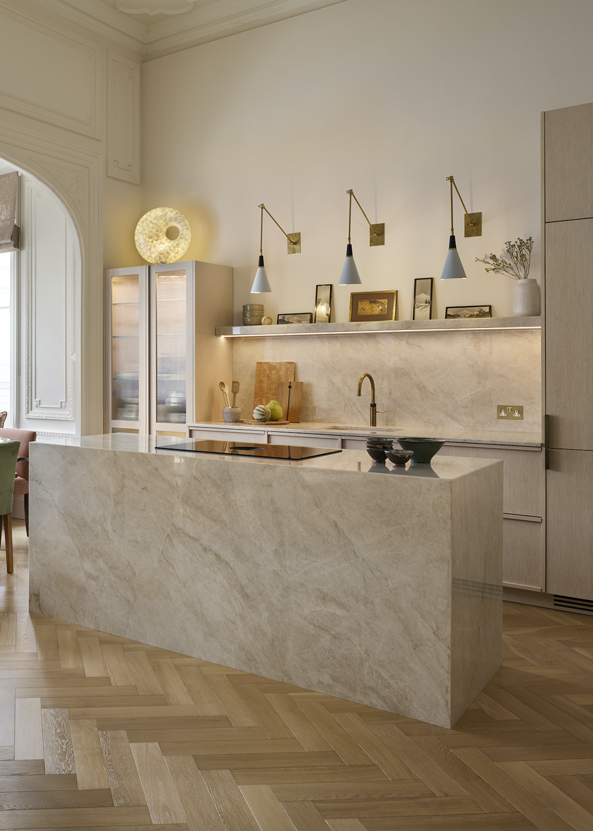 Stone kitchen with layered lighting and wood floors