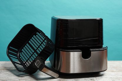 An electric Air Fry on table with blue background