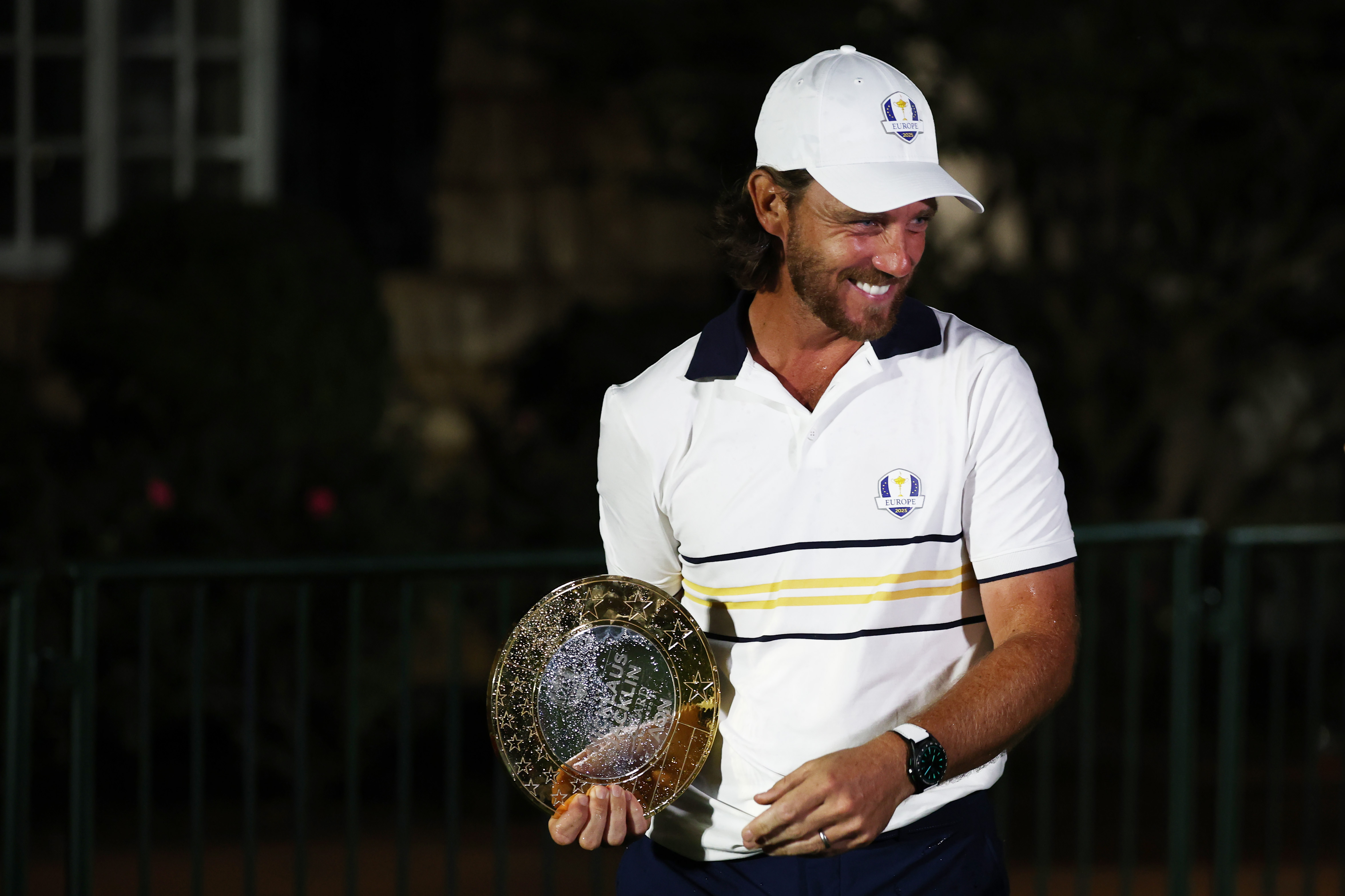 Tommy Fleetwood poses with the Nicklaus-Jacklin award in the dark at Bethpage in 2025