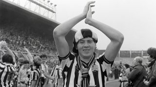 NEWCASTLE UPON TYNE, ENGLAND - MAY 05: Newcastle forward Chris Waddle wearing a hat and scarf salutes the fans in the Gallowgate end after their 4-0 victory over Derby County which all but seals Promotion to Division One on May 5th, 1984 at St James' Park in Newcastle upon Tyne, England. (Photo by Danny Brannigan/Hulton Archive)