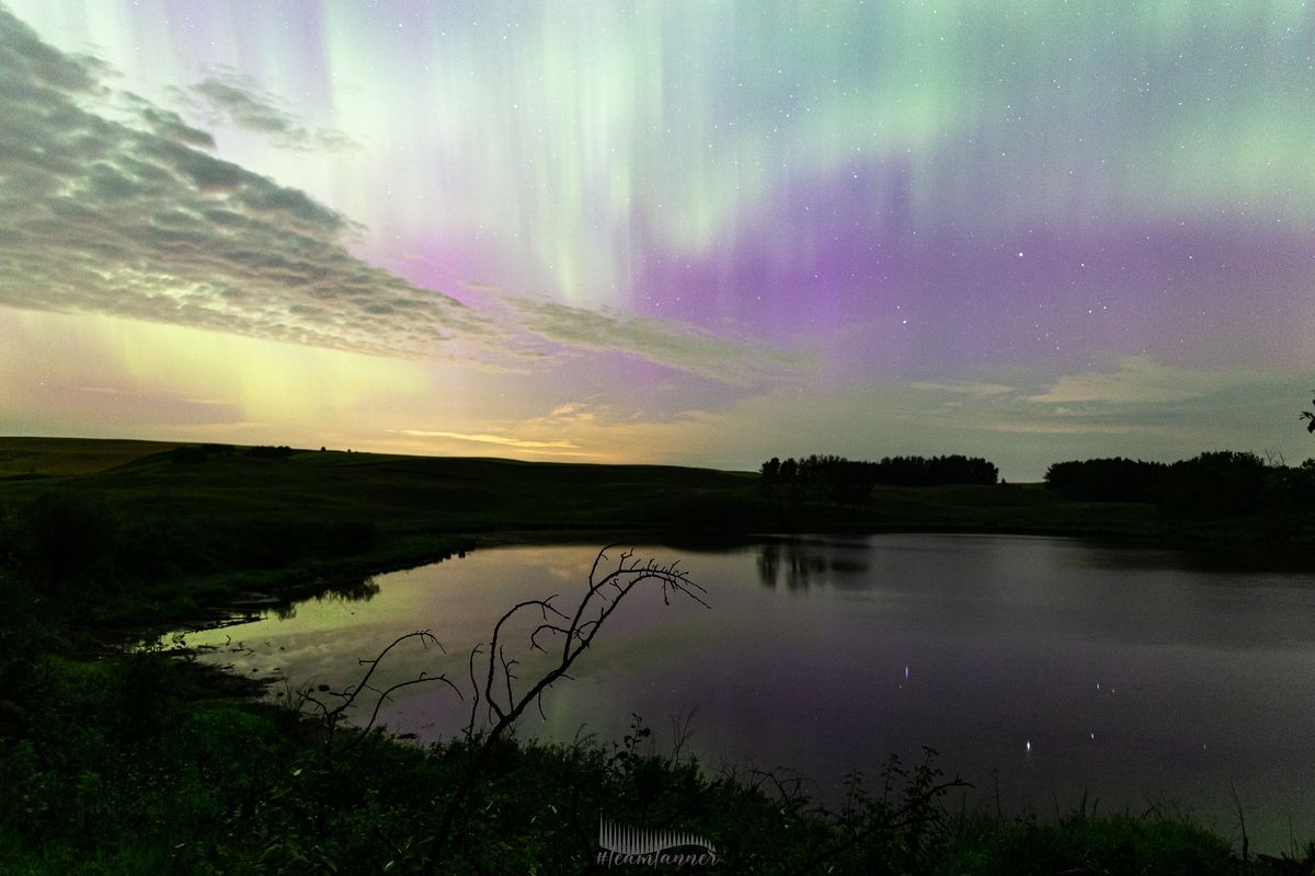 northern lights appearing as huge curtains of green light rippling along the sky.