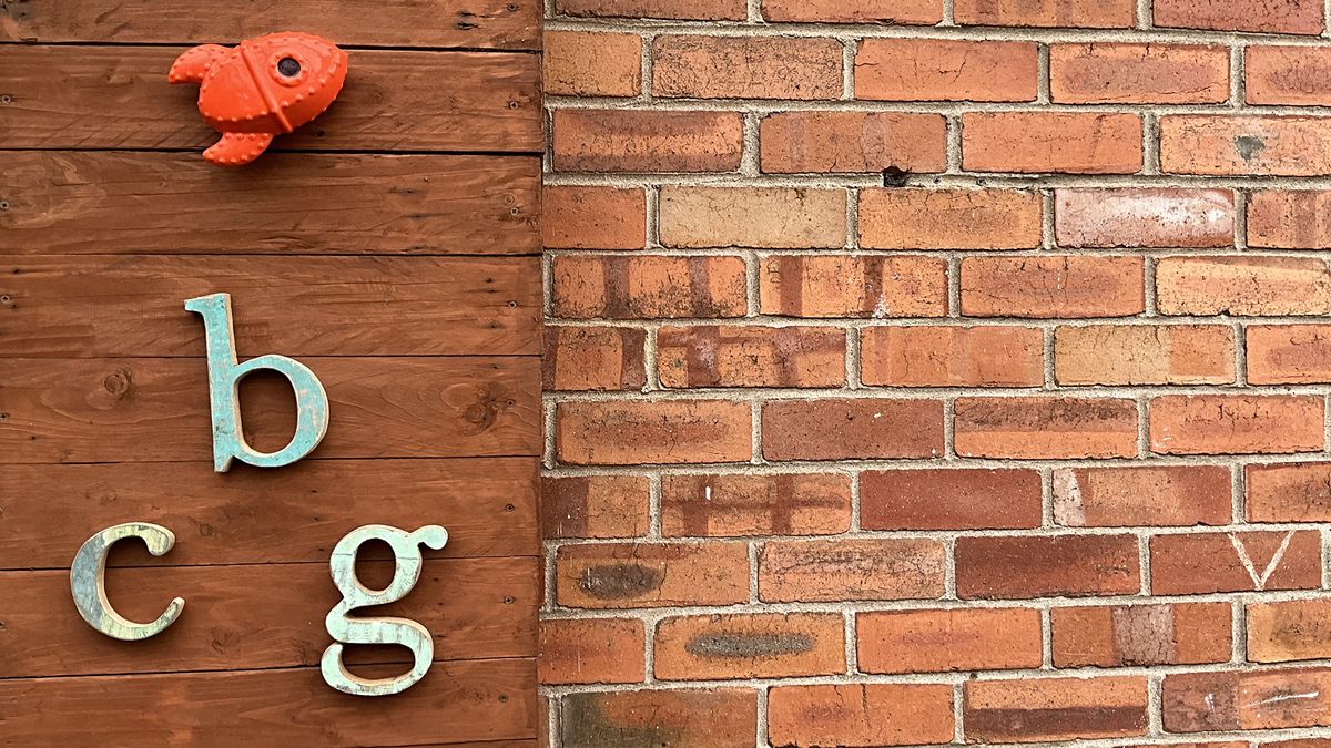 Wooden letters b, c and g on a wooden panel.