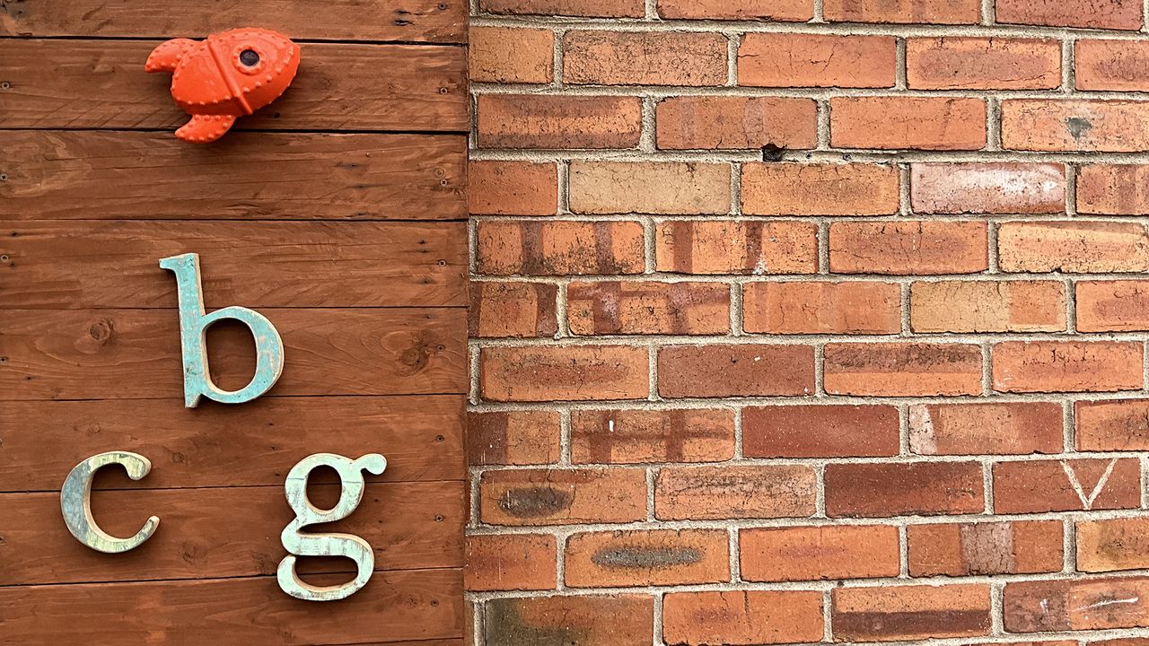 Wooden letters b, c and g on a wooden panel.