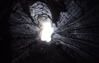 An image shows the entrance to the salt cave under Mount Sedom. 