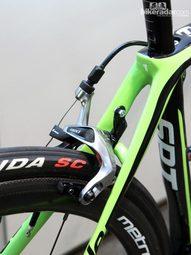SRAM Red brake calipers are equipped with carbon-specific pads. Note the carbon fiber number plate holder, too